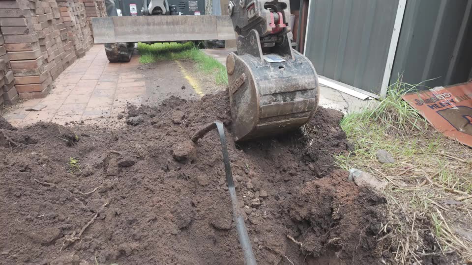 Garden bed cut — tight access behind the house — real AOI job
